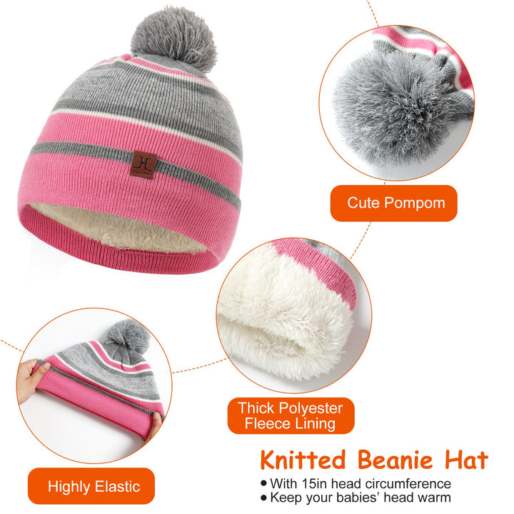 Child wearing striped pompom hat, snood and gloves