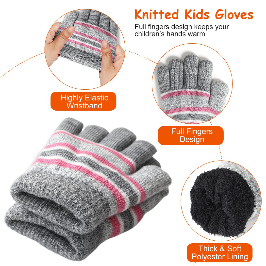 Child wearing striped pompom hat, snood and gloves